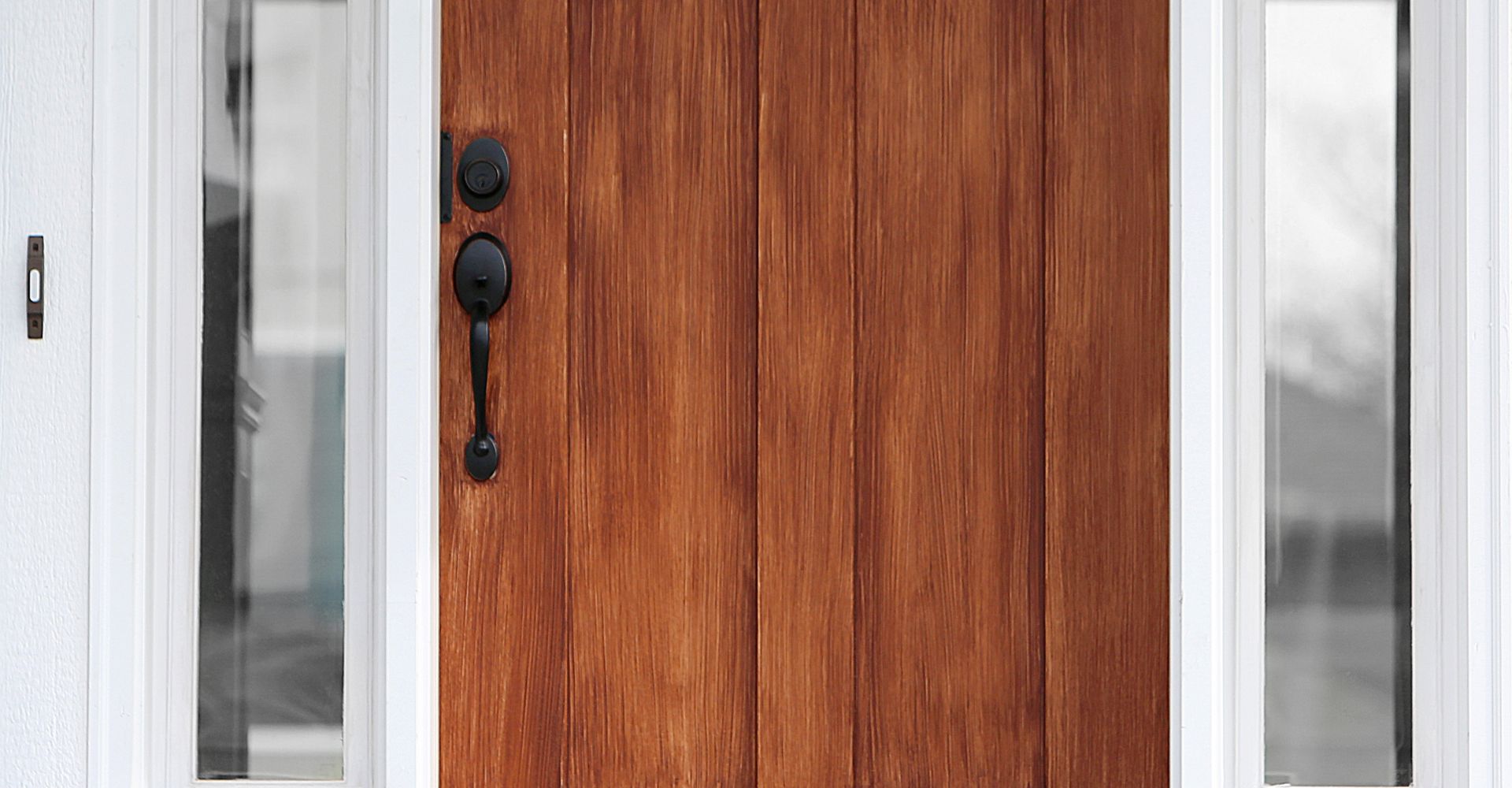 Closeup of wooden door with black hardware