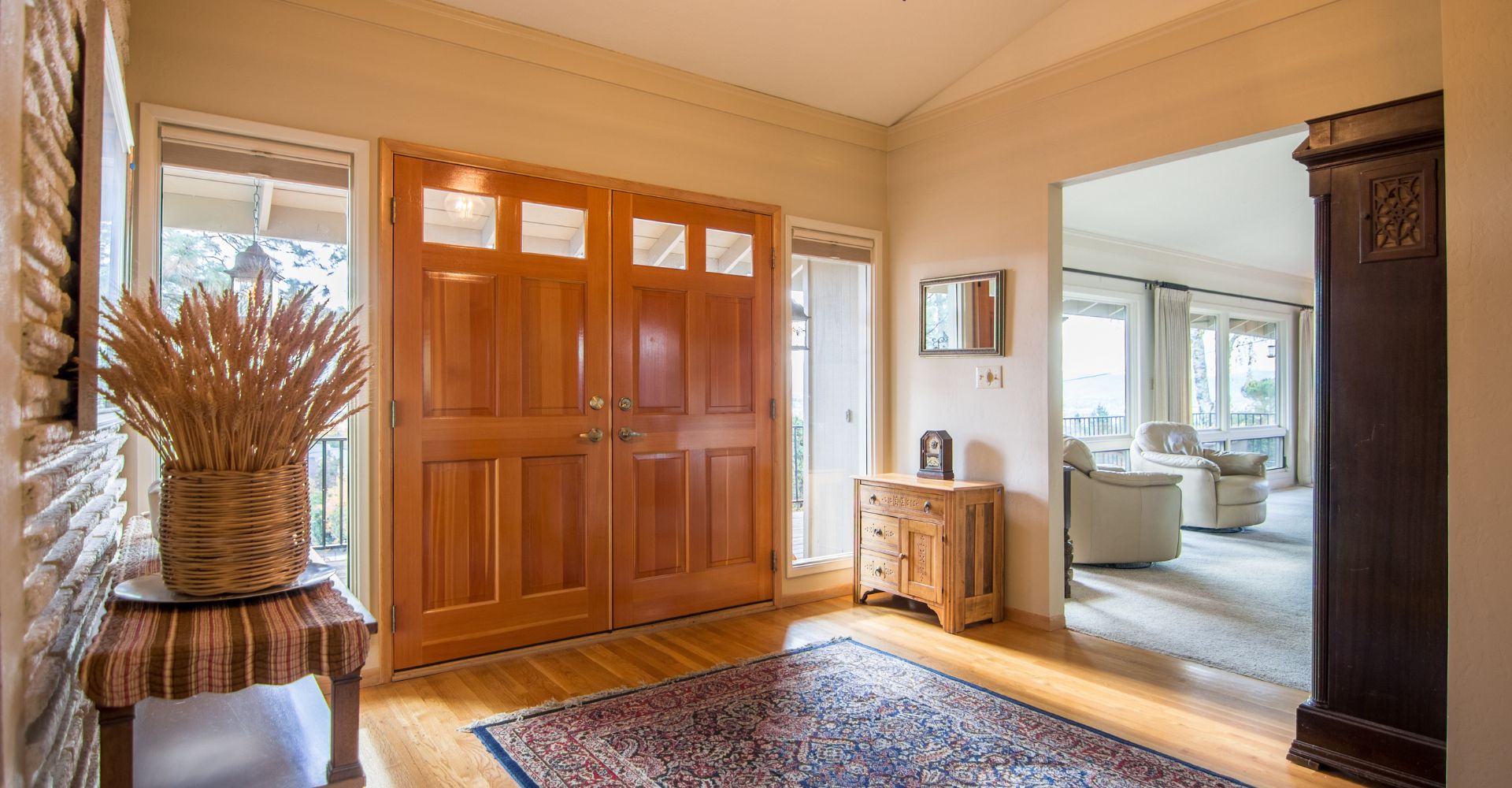 a double wooden door with glass inlay