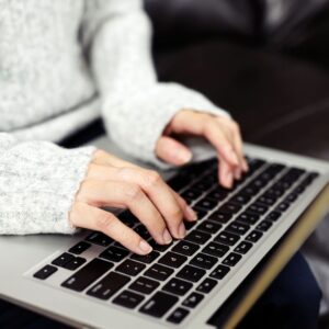 closeup of someone typing on a laptop