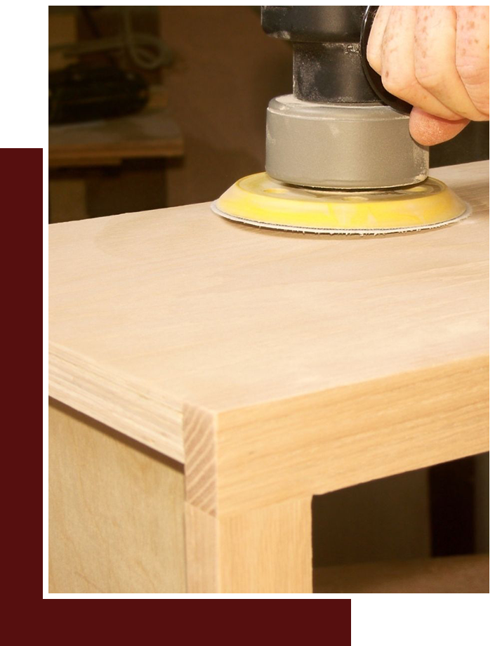 close up of sanding wood cabinet