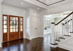 modern home entrance with large wooden door